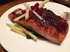 Spicy Maple Salmon With Apples and Pomegranate Seeds on a Bed of Sauteed Spinach 